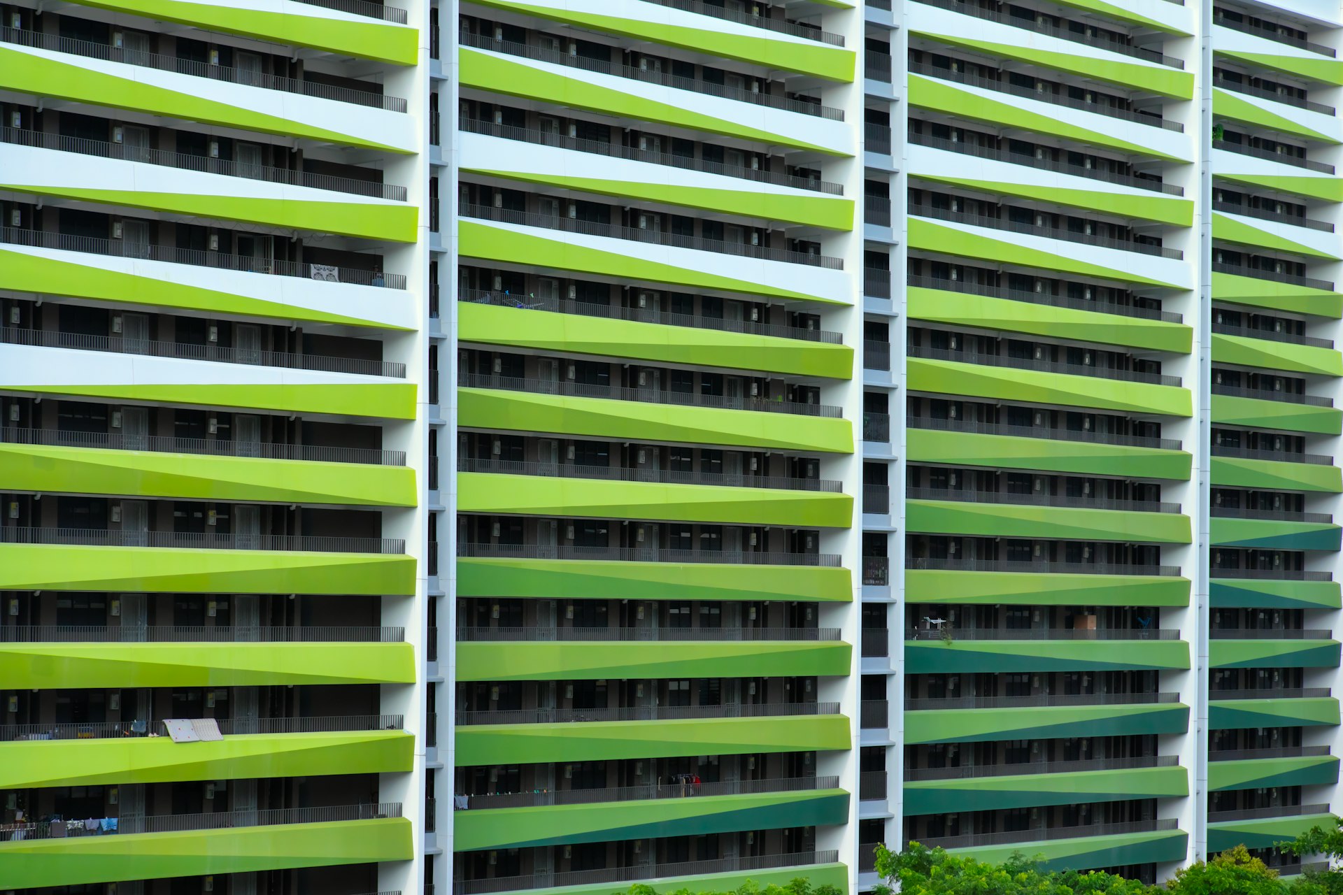a tall building with many windows and green shutters